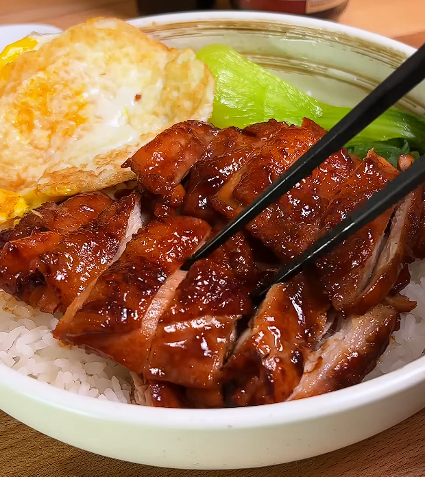 char siu chicken served in bowl of rice with fried egg