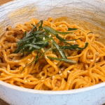 chili peanut noodles served in bowl