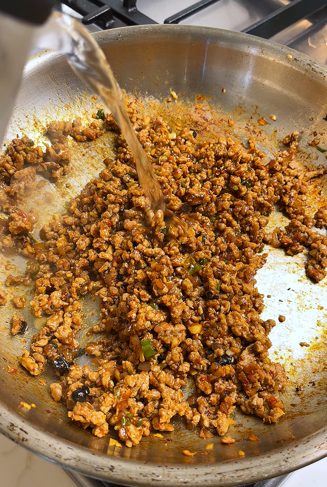 adding water to ground pork